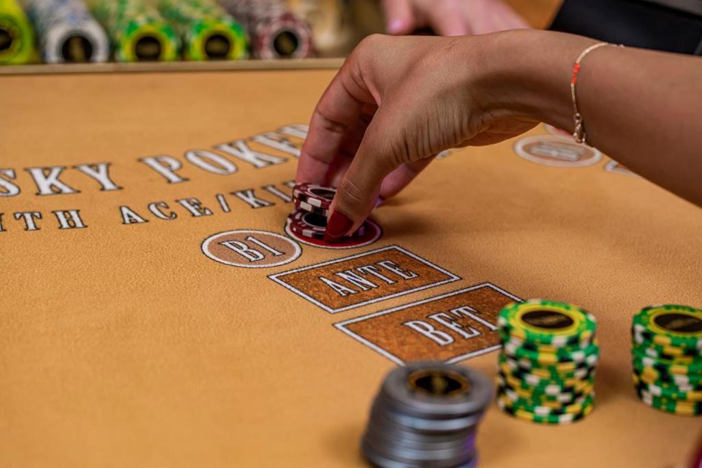 Savoy Hotel Spa & Casino Kerínia Kültér fotó A player placing a bet on the "18" or "black" section of a roulette table